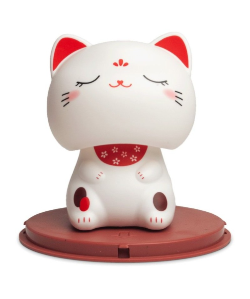 White cat-shaped figurine with red accents on a white background