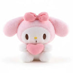 Plush toy with pink bow and heart on a beige background