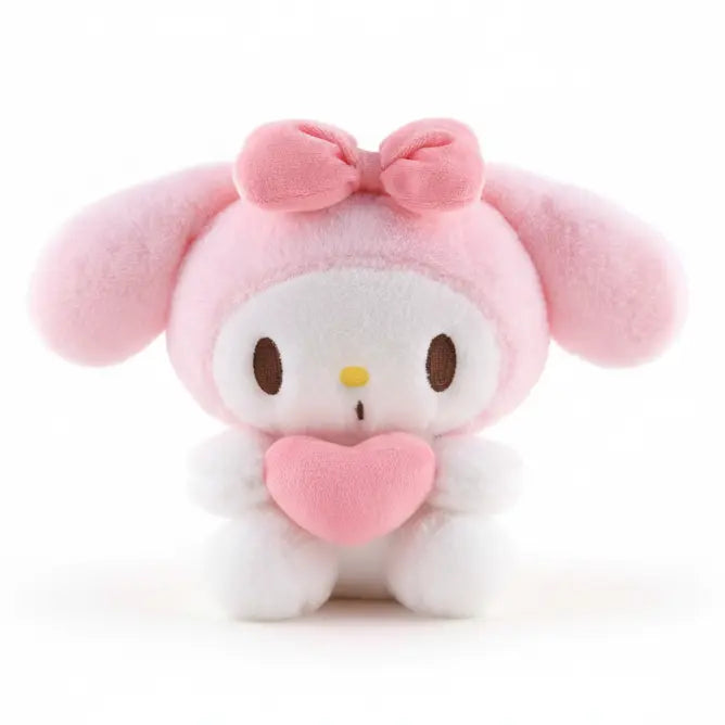 Plush toy with pink bow and heart on a beige background