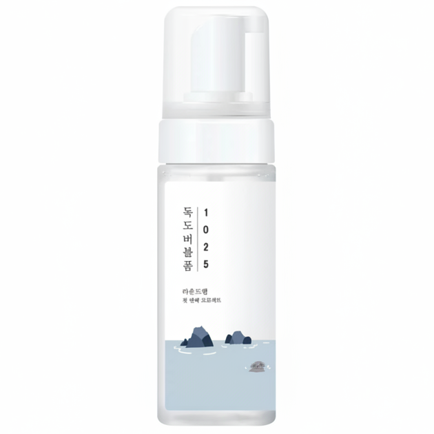 A frosted glass pump bottle with a white cap and a minimalist label featuring a light blue water design with dark blue rocks and vertical Korean text reading '1025'.