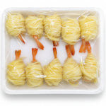 Ten small shrimp cocktail skewers wrapped in pale yellow sauce, arranged in a white styrofoam tray and covered with clear plastic wrap, shown against a white background.