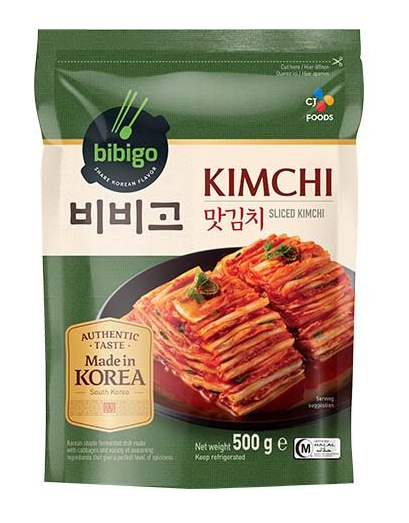 A 500g package of bibigo Kimchi Sliced Kimchi, featuring a dark green and cream-colored stand-up pouch with a photo of the sliced red kimchi on the front.