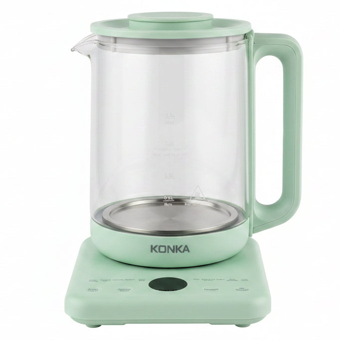 A Konka countertop electric milk boiler or blender in mint green, featuring a clear glass jar with a white inner bag, set on a white shelf with product packaging boxes visible on both sides.