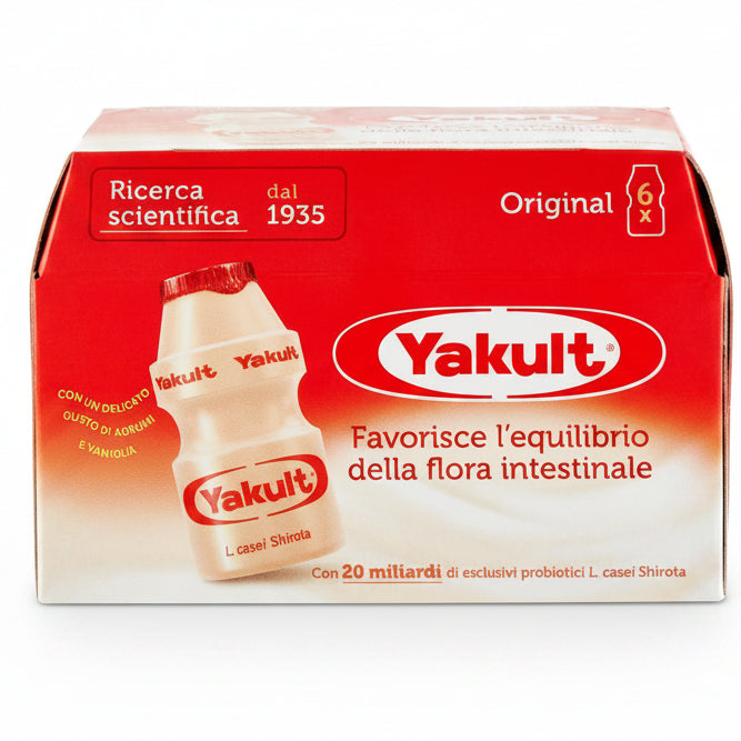 A box of Yakult Original L-casei Shirota probiotic yogurt, featuring a red and white packaging design with a graphic of a single bottle of the creamy off-white yogurt.