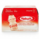 A box of Yakult Original L-casei Shirota probiotic yogurt, featuring a red and white packaging design with a graphic of a single bottle of the creamy off-white yogurt.